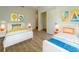 Bright and cheerful bedroom with two twin beds, vibrant decor, and ample natural light at 1235 19Th St, Orlando, FL 32805
