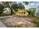 Charming yellow home featuring a garage, a well manicured yard, and a new driveway at 1235 19Th St, Orlando, FL 32805