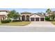 Exterior of a stunning house with a three-car garage and attractive landscaping at 1484 Via Sangro Pl, Winter Park, FL 32792