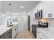 Stylish kitchen includes stainless steel appliances, an island with a sink, and wood floors throughout the space at 14962 Sw 39Th Cir, Ocala, FL 34473