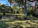 Large backyard with lush landscaping and a patio area at 1520 Moravia Ave, Holly Hill, FL 32117