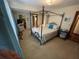 Bedroom with a metal canopy bed, TV, and ensuite bathroom at 1520 Moravia Ave, Holly Hill, FL 32117
