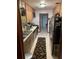 Galley kitchen with wood cabinets and stainless steel appliances at 1520 Moravia Ave, Holly Hill, FL 32117