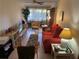Living room with red couch and window seating at 1520 Moravia Ave, Holly Hill, FL 32117