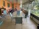 Large screened porch with seating and outdoor table at 1520 Moravia Ave, Holly Hill, FL 32117