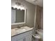 Bright bathroom features a vanity with granite counters and shower with marble tile surround at 1621 Pear Ave, Sanford, FL 32771