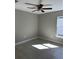 Bedroom with neutral walls, ceiling fan, light-filled window, and tile floors at 1621 Pear Ave, Sanford, FL 32771