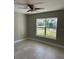 Bright bedroom features a ceiling fan, natural light, and a view of the lawn at 1621 Pear Ave, Sanford, FL 32771