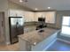 Bright kitchen featuring white cabinetry, stainless steel appliances, and a granite countertop island at 1621 Pear Ave, Sanford, FL 32771