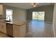 Open-concept layout with granite countertop, stainless steel appliances, and sliding glass door to the backyard at 1621 Pear Ave, Sanford, FL 32771