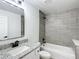 Modern bathroom with granite countertop, gray tile, and a bathtub at 22474 Sw Rainbow Lakes Blvd, Dunnellon, FL 34431