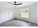 Bright bedroom with wood-look floors, large window, and double doors at 22474 Sw Rainbow Lakes Blvd, Dunnellon, FL 34431