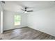 Bright bedroom with vinyl plank flooring, ceiling fan and window at 22474 Sw Rainbow Lakes Blvd, Dunnellon, FL 34431