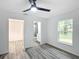 Spacious bedroom with wood-look floors and ensuite bathroom access at 22474 Sw Rainbow Lakes Blvd, Dunnellon, FL 34431