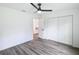 Bedroom with wood-look floors, large window, and ceiling fan at 22474 Sw Rainbow Lakes Blvd, Dunnellon, FL 34431