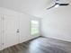 Bright living room with vinyl plank flooring, ceiling fan, and large window at 22474 Sw Rainbow Lakes Blvd, Dunnellon, FL 34431