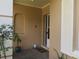 House entrance with a screen door and plants at 237 S Shadowbay Blvd, Longwood, FL 32779