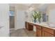 Double vanity bathroom with a large mirror and shower at 256 Yellow Snapdragon Dr, Davenport, FL 33837