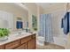 Bathroom with a tub shower and wood vanity at 256 Yellow Snapdragon Dr, Davenport, FL 33837