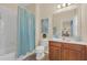 Bathroom with a tub shower and wood vanity at 256 Yellow Snapdragon Dr, Davenport, FL 33837