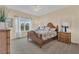 Cozy bedroom with a queen-size bed and carpeted floors at 256 Yellow Snapdragon Dr, Davenport, FL 33837