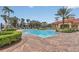 Relaxing community pool with brick patio and lounge chairs at 256 Yellow Snapdragon Dr, Davenport, FL 33837