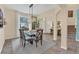 Formal dining room with a glass-top table and chandelier at 256 Yellow Snapdragon Dr, Davenport, FL 33837
