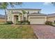 Two-story house with a two-car garage and landscaped front yard at 256 Yellow Snapdragon Dr, Davenport, FL 33837
