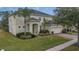 Two-story house with green door and landscaping at 256 Yellow Snapdragon Dr, Davenport, FL 33837