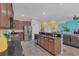 Open concept kitchen with island and stainless steel appliances at 256 Yellow Snapdragon Dr, Davenport, FL 33837