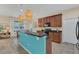 Modern kitchen with dark wood cabinets and a teal island at 256 Yellow Snapdragon Dr, Davenport, FL 33837