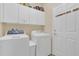 Bright laundry room with washer, dryer, and ample storage at 256 Yellow Snapdragon Dr, Davenport, FL 33837
