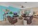 Relaxing living room with leather couches and a teal accent wall at 256 Yellow Snapdragon Dr, Davenport, FL 33837