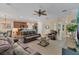 Spacious living room with brown leather furniture and a ceiling fan at 256 Yellow Snapdragon Dr, Davenport, FL 33837