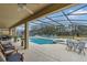 Relaxing pool area with covered patio and seating at 256 Yellow Snapdragon Dr, Davenport, FL 33837