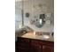 Bathroom features granite countertops and an oval mirror at 4392 Sambourne St, Clermont, FL 34711