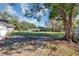 Large backyard with mature trees and grassy area at 805 Willow Ave, Sanford, FL 32771