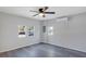 Bedroom with ceiling fan, grey flooring, and two windows at 805 Willow Ave, Sanford, FL 32771