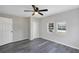 Bedroom with ceiling fan, two windows, and grey vinyl plank flooring at 805 Willow Ave, Sanford, FL 32771