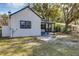 White house with dark trim, covered porch, and satellite dish at 805 Willow Ave, Sanford, FL 32771