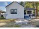 White house with gray accents, covered porch, and side yard at 805 Willow Ave, Sanford, FL 32771