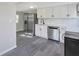 Modern kitchen with stainless steel appliances and white cabinets at 805 Willow Ave, Sanford, FL 32771