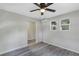 Living room with gray walls, gray flooring, and blue door at 805 Willow Ave, Sanford, FL 32771