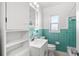 Clean bathroom with teal tile, white vanity and shower/tub combo at 811 Briercliff Dr, Orlando, FL 32806