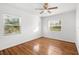 Hardwood floor bedroom with ceiling fan and two windows at 811 Briercliff Dr, Orlando, FL 32806