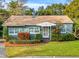 Charming light-green house with well-maintained landscaping at 811 Briercliff Dr, Orlando, FL 32806