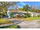 Exterior view of a charming light green house with landscaping at 811 Briercliff Dr, Orlando, FL 32806