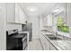 Updated kitchen with white cabinets and granite counters at 811 Briercliff Dr, Orlando, FL 32806