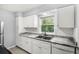 Updated kitchen features white cabinets, granite countertops, and stainless steel appliances at 811 Briercliff Dr, Orlando, FL 32806