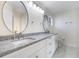 Modern bathroom with double sinks, granite countertop, and decorative vanity lighting at 10632 Whitestone Ct, Orlando, FL 32817